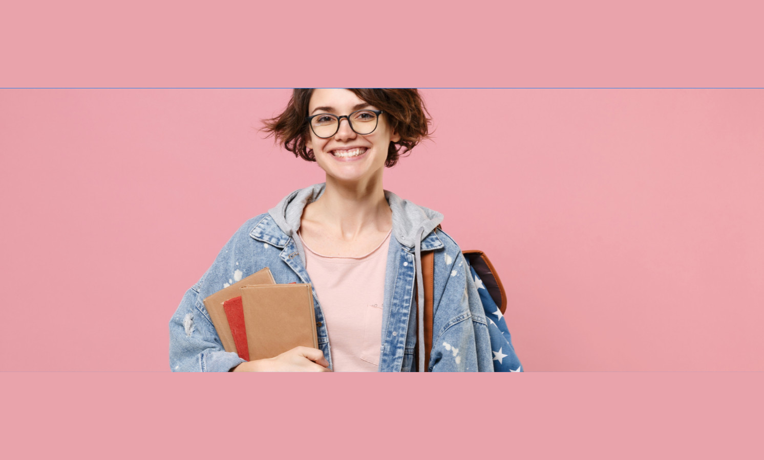 Girl smiling with short hair wearing a tshirt and jacket, with a a bag on one shoulder holding some books.